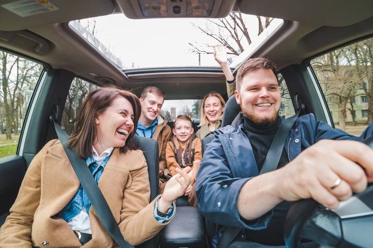 friends in car with little kid. car travel concept. adventure time