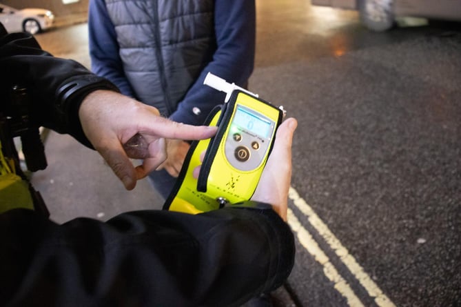 Officer holding digital breathalyser