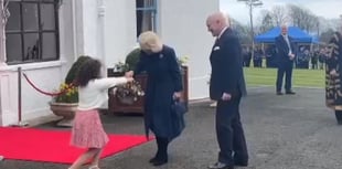 Watch the moment Queen Camilla is presented with flowers by schoolgirl