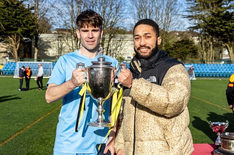 Rushen United captain Ste Riding receives the FA Cup from Luke Adebiyi of competition sponsor ECAP (Photo: Gary Weightman)