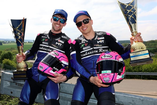 Harry Payne (left) and French co-pilot Kevin Rousseau celebrate with their trophies after their double success in the  at the German GP of the FIM Sidecar World Championship last weekend (Photo: Mark Walters)