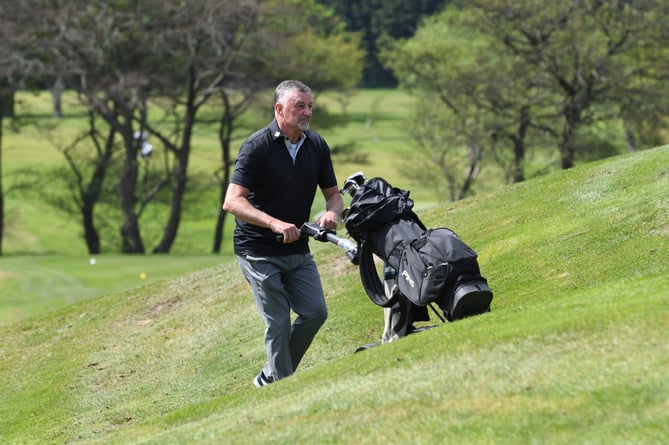 John Aldridge carrying his clubs at Ramsey Golf Club at the charity golf day in aid of Craig Heartstrong Foundation