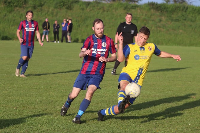 Foxdale's Liam Cannan (left) closes down Onchan's Tom O'Neill during Monday evening's Gold Cup semi-final at Billy Goat Park (Photo: Paul Hatton)