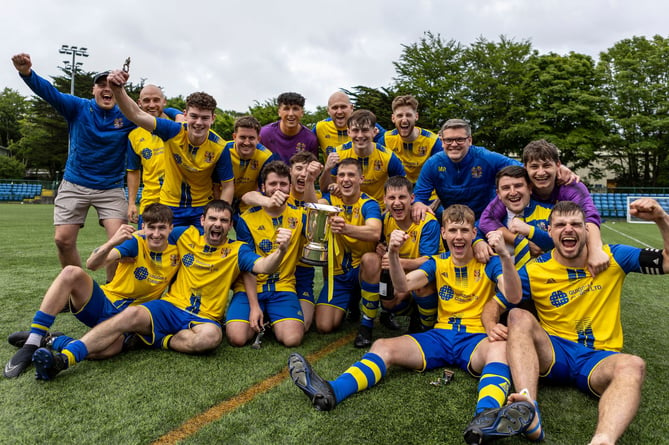 Onchan players and coaches celebrate with the Paul Henry Gold Cup after defeating Castletown 5-1 in the final at the Bowl on Sunday (Photo: Gary Weightman)