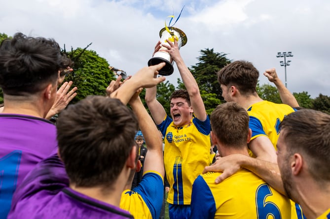 Onchan captain James Kerruish hoists the Gold Cup aloft to kickstart the celebrations at the Bowl (Photo: Gary Weightman)