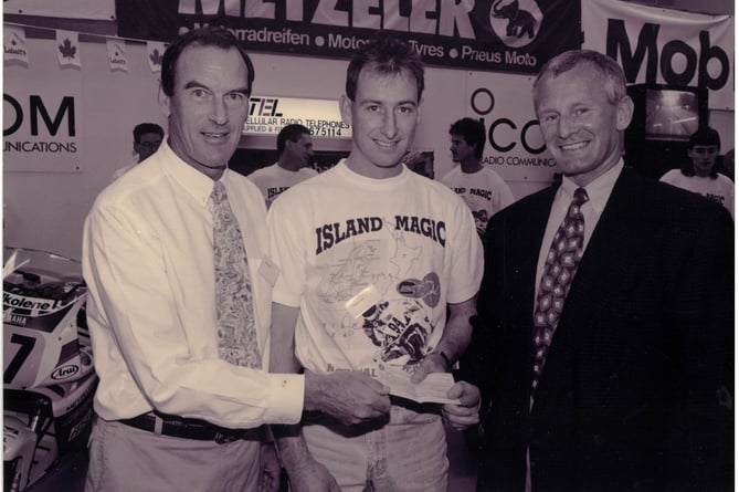 New Zealand team co-ordinator John Shand (left) with the then Isle of Man Tourism Minister Allan Bell presenting John Hepburn with his scholarship cheque. He was one of 15 kiwis in the 1994 Supersport TT 