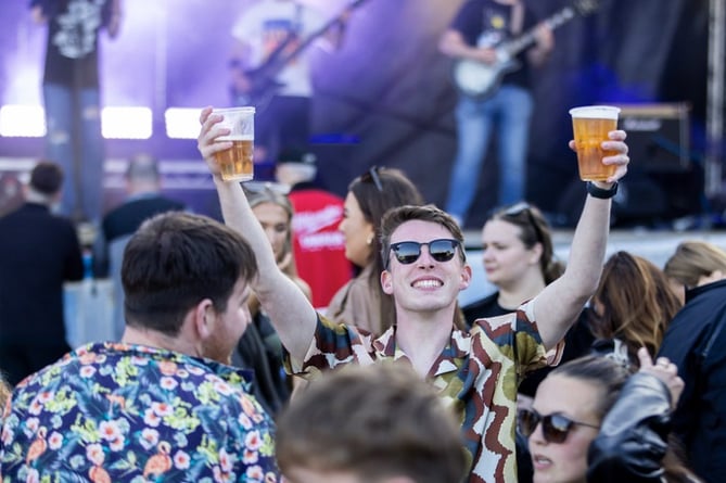 A music fan enjoying a pint or two at the Bushy's TT Village 2024