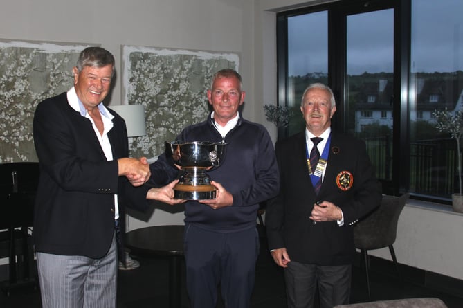 Simon Kirkpatrick (left) presents the WA Kirkpatrick Trophy to winner Peter Glover alongside Isle of Man Golf president and Stephen Worthing