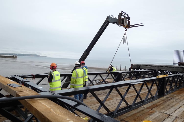 A girder is lowered into position on bay 8 of Queen's Pier