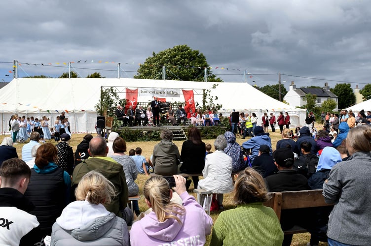 Attendees look on at the opening ceremony