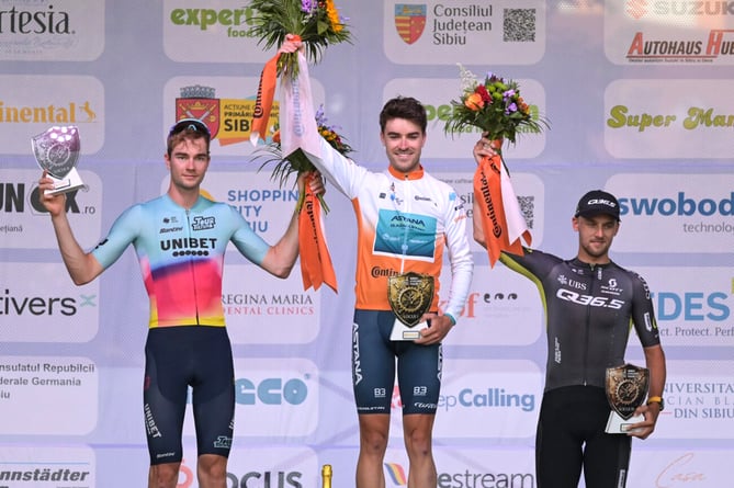 Max Walker (centre) celebrates on the top step of the podium after winning the individual time trial on the second day of the Sibiu Cycling Tour in Romania on Sunday (Photo: Dragoș Dumitru)