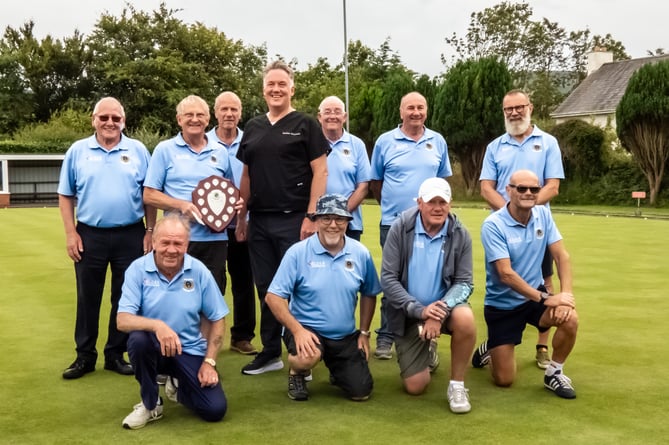 Ballaugh B were recently crowned champions of Division Two in the over-60s men's bowls league. They are pictured receiving the shield from Guy Wolstencroft of league sponsor Isle of Man Hearing Solutions (Photo: Norman Kneen)