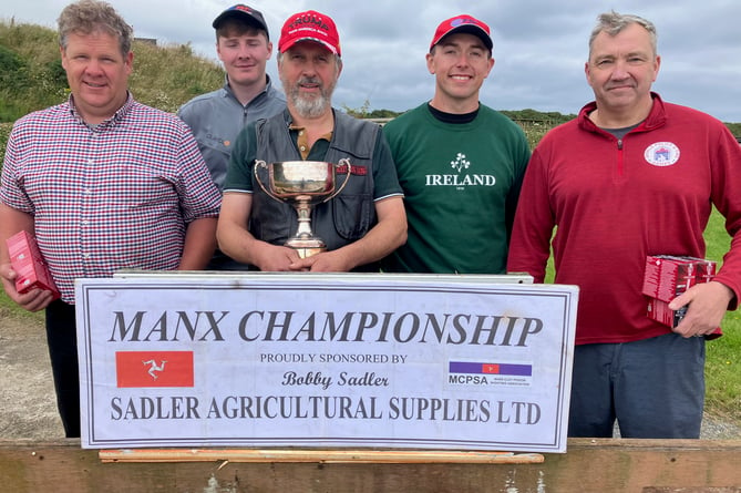 Some of the prizewinners in thee DLT Championship at Isle of Man Clay Pigeon Shooting Club last weekend, including overall winner Mike Walk with the trophy