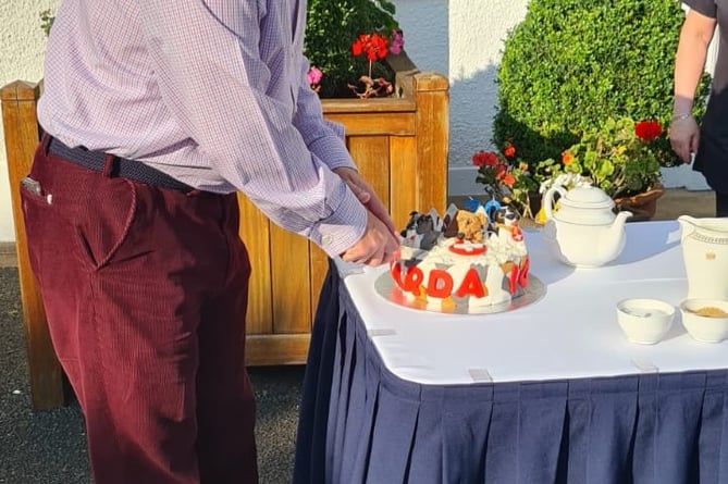 Lieutenant Governor Sir John Lorimer cuts the special cake celebrating the 20th anniversary of the charity 