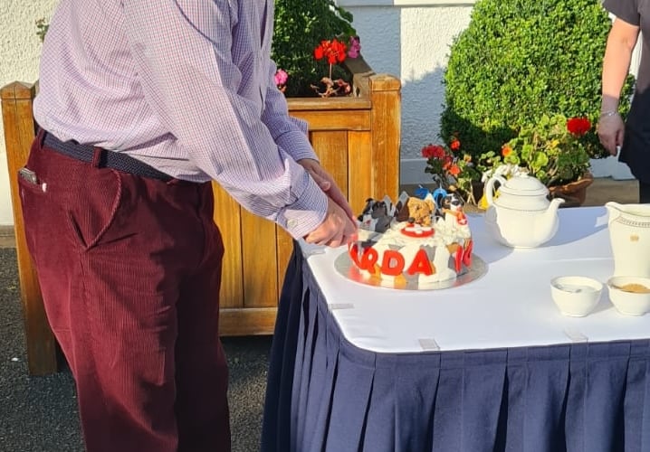 Lieutenant Governor Sir John Lorimer cuts the special cake celebrating the 20th anniversary of the charity 