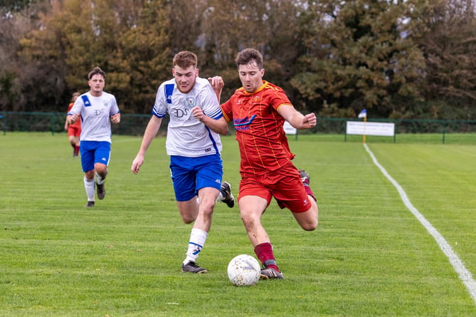 Douglas Royals will be playing football in the DPS Limited Division Two this season, swapping places with Marown. 
Pictured is Lucas Watterson (white) and Marown's Connor Gilbert (maroon) when the sides met in February this year at Ballafletcher