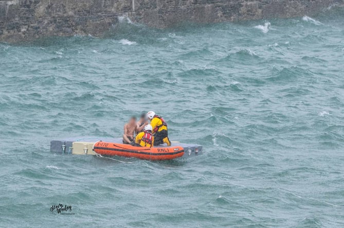 Emergency crews rescuing the two individuals in Ramsey Bay