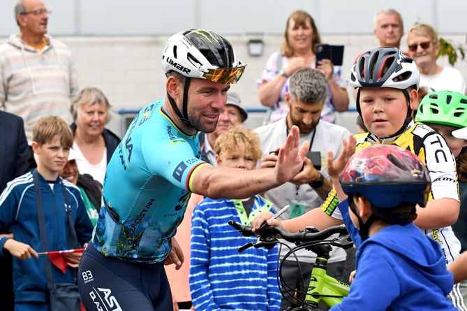 Sir Mark Cavendish high-fives a young cyclist as he greets his fans during his three laps of honour at the NSC on Friday, held to mark his record-breaking 35th stage win at this year's Tour de France (Photo: Dave Kneale)