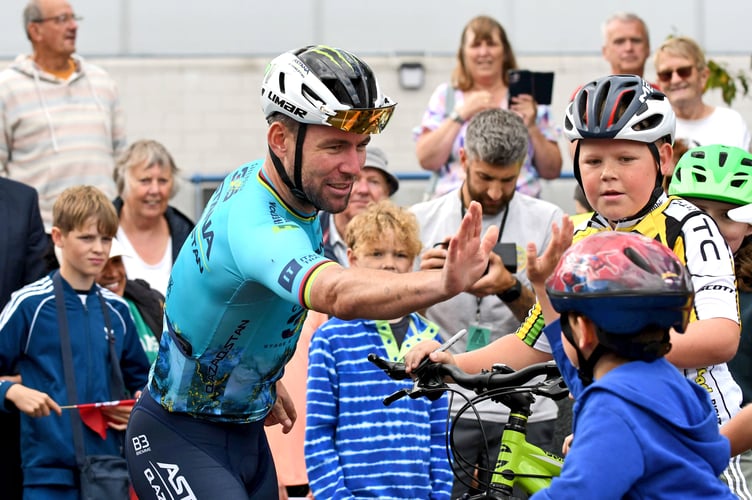 Sir Mark Cavendish high-fives a young cyclist as he greets his fans during his three laps of honour at the NSC on Friday, held to mark his record-breaking 35th stage win at this year's Tour de France (Photo: Dave Kneale)