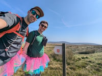 Friends walk the length of the island with their legs tied together