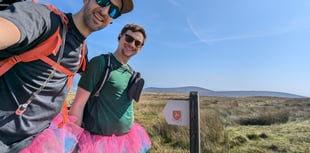 Friends walk the length of the island with their legs tied together