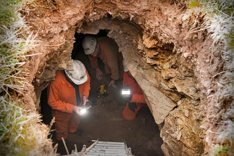 Three members of the Laxey Mines Research Group comfortably fit into the sinkhole at the Chasms