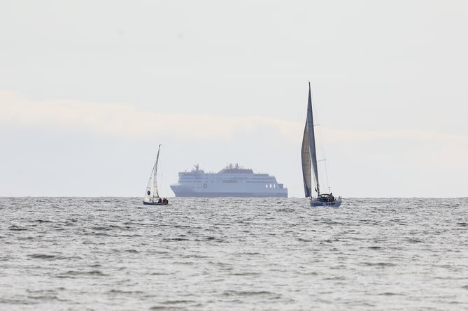 Manxman celebration cruise passing a yacht race at Gansey Beach