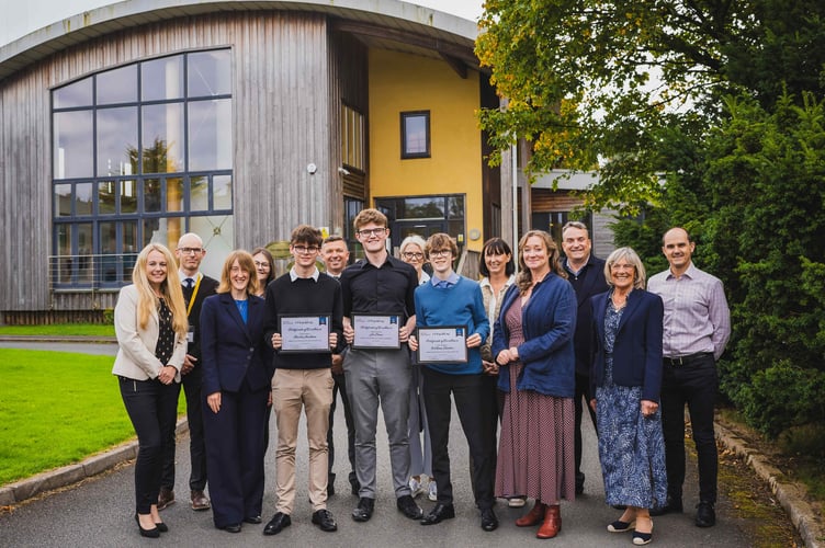 Students with family members, Education Minister Daphne Caine, River Advisers staff and school staff