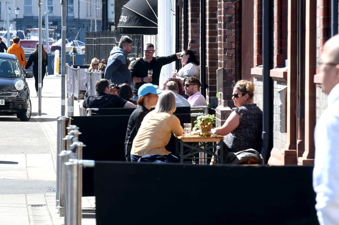 People enjoying drinks on North Quay in Douglas