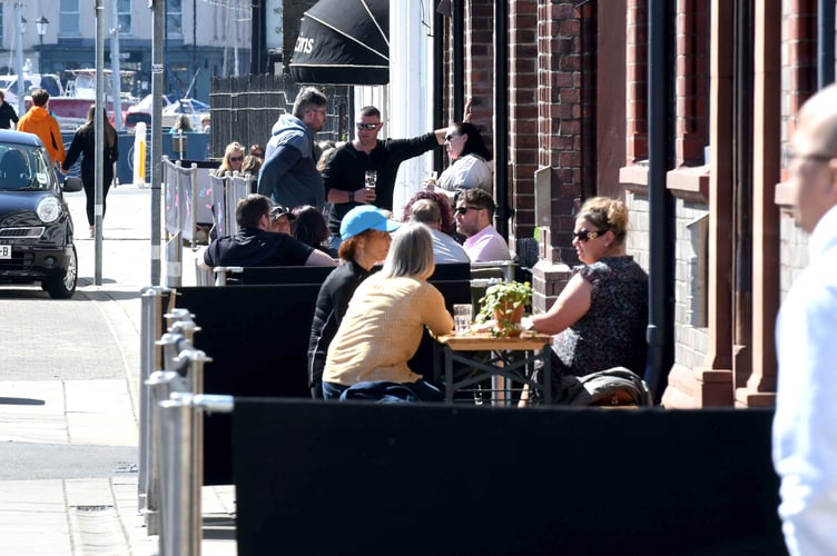 People enjoying drinks on North Quay in Douglas