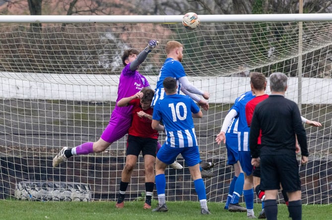 Ramsey goalkeeper James Rice leaps high to attempt to punch clear a ball against Onchan during the two sides' Canada Life Premier League clash at the Nivison Stadium. Rice kept a clean sheet in a goalless draw to earn his place in Team of the Week (Photo: Gary Weightman)