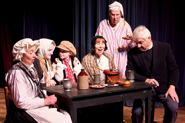 Left to right: Adrienne Sanderson as Mrs Cratchit, Lila Quine as Belinda, Mia Quine as Tiny Tim, Louise Drinkwater as Martha and Graham Roberts as Bob Cratchit (all photos - Andrea Thrussell of the Southern Photographic Society)