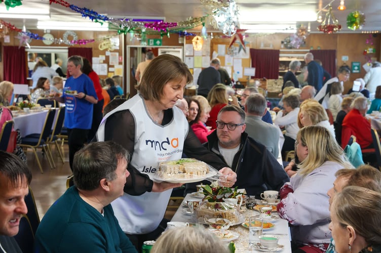 Volunteers served food to those attending an afternoon tea fundraiser in aid of the Isle of Man MND charity