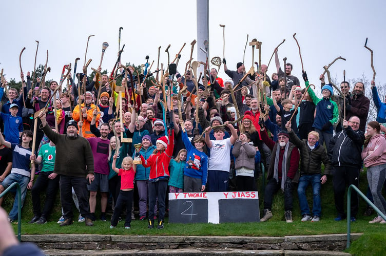 Cammag participants raise their sticks aloft in St John's at last year's Boxing Day event