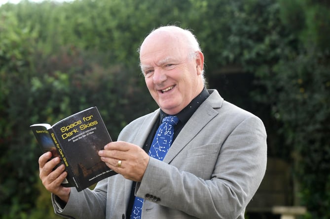 Astronomer Howard Parkin with his book Space for Dark Skies