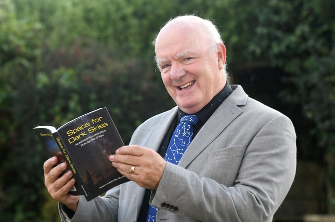 Astronomer Howard Parkin with his book Space for Dark Skies