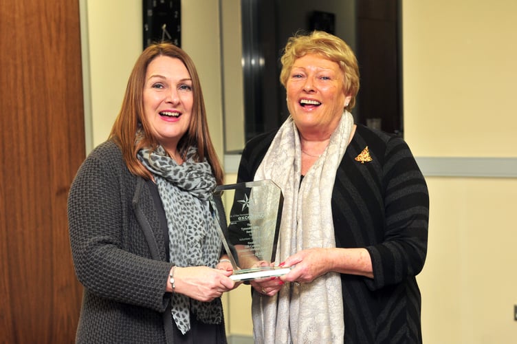 Gilli Cowley (right) receiving her Media Isle of Man Awards for Excellence Volunteer of the Year trophy from Sarah Radcliffe back in 2014