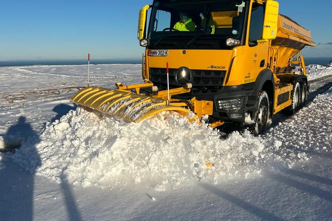 The department has three gritters and a tractor-mounted snow blower operating on the Mountain Road, with plans to move on to Beinn-y-Phott and Tholt-y-Will once conditions allow.