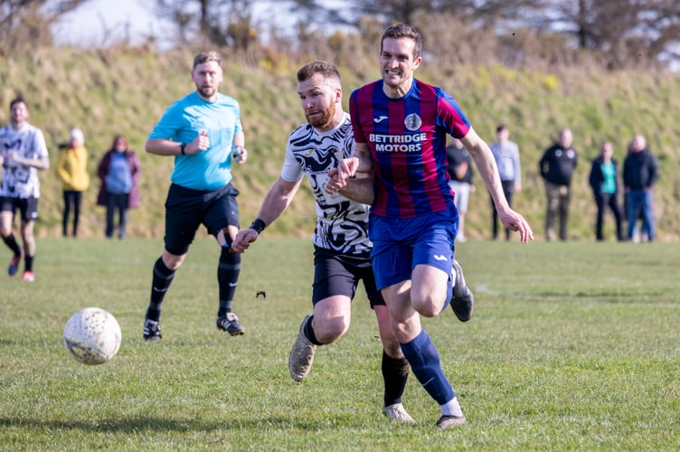 Foxdale's Jay Chatwood (right) attempts to escape the attentions of Colby's Will Cain during last Saturday's ECAP FA Cup quarter-final at Billy Goat Park. Chatwood scored twice to earn his place in the latest Team of the Week (Photo: Gary Weightman)